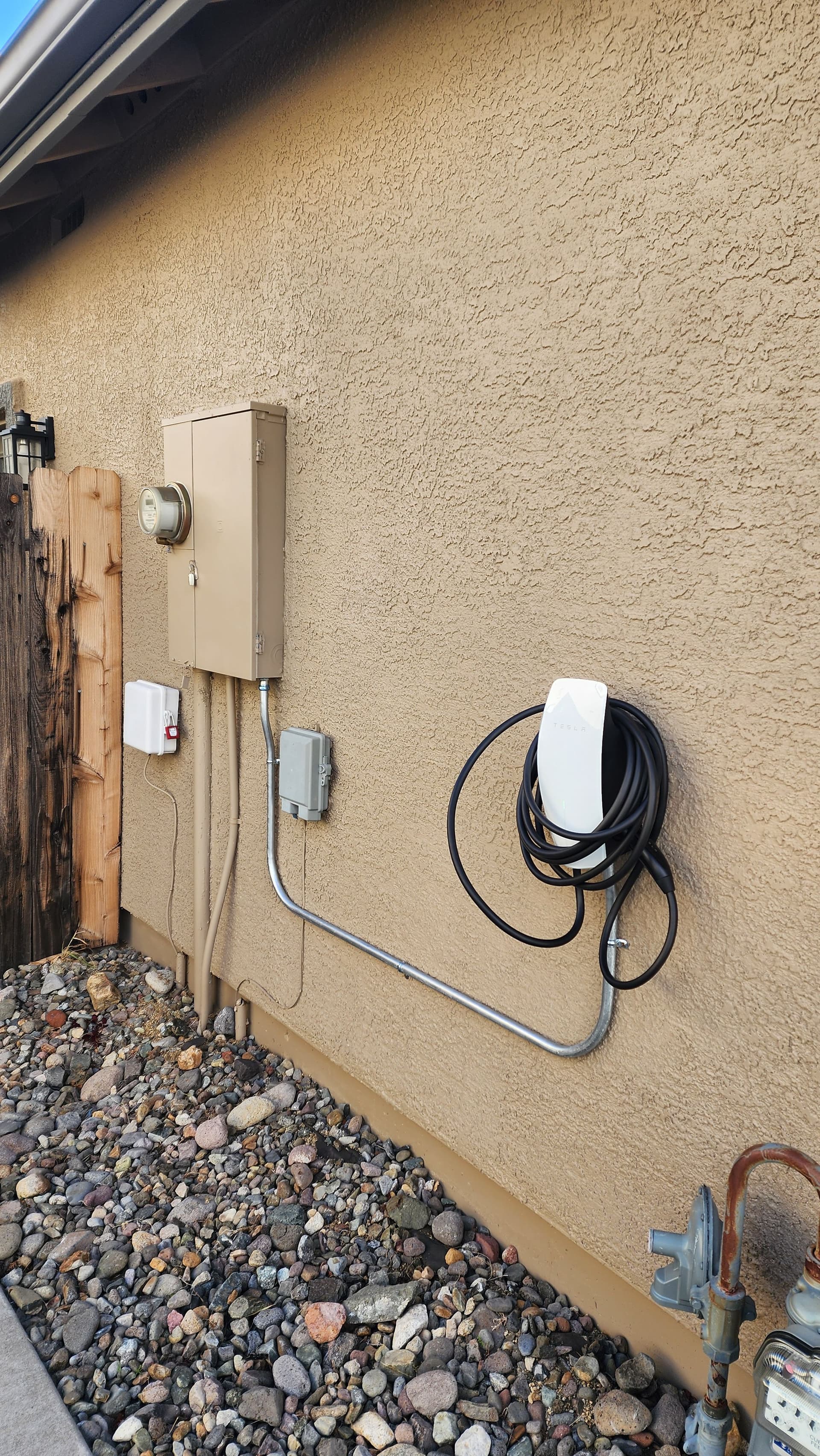 Tesla Wall Connector Installed on Garage Exterior image