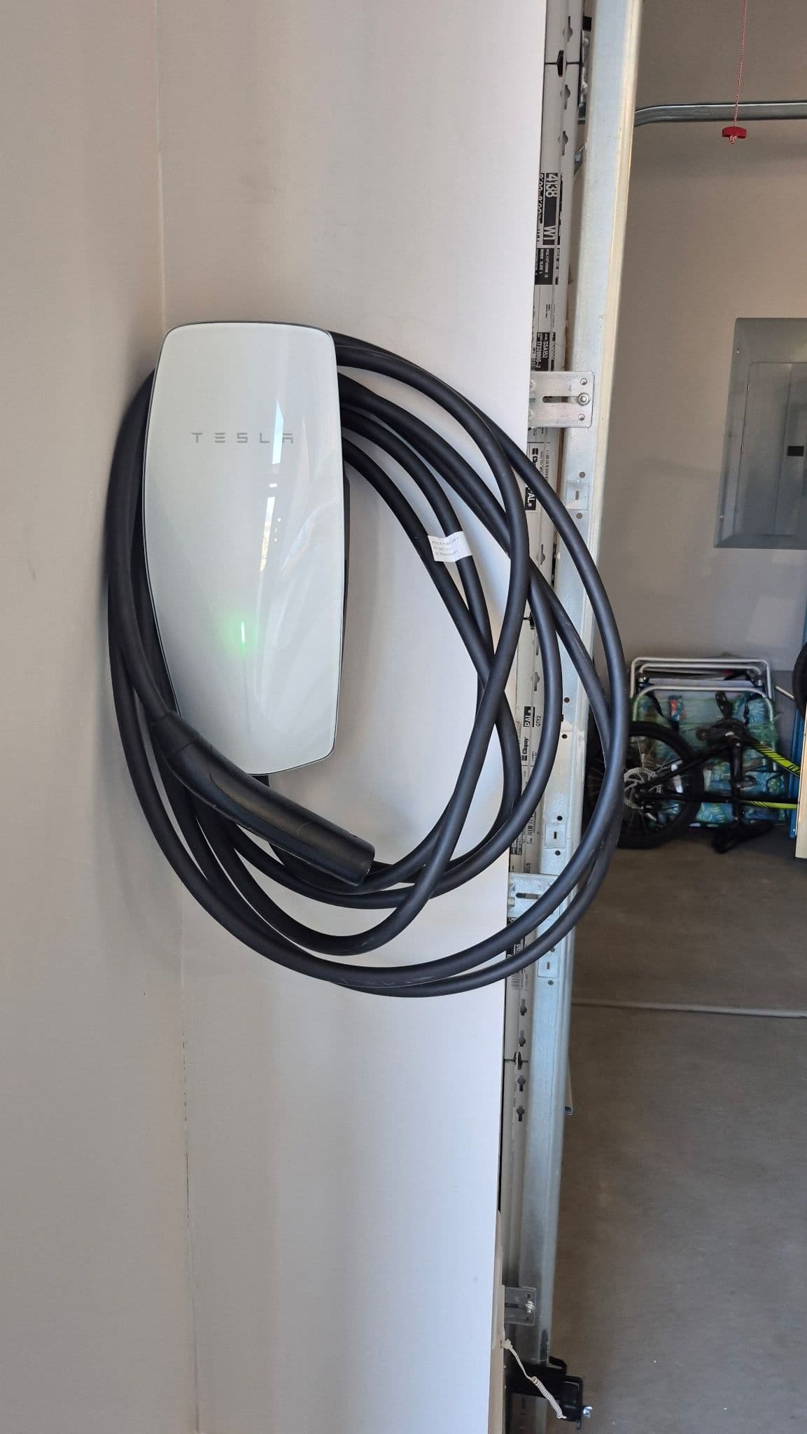 Tesla Wall Connector Installed in a Garage the Right Way image