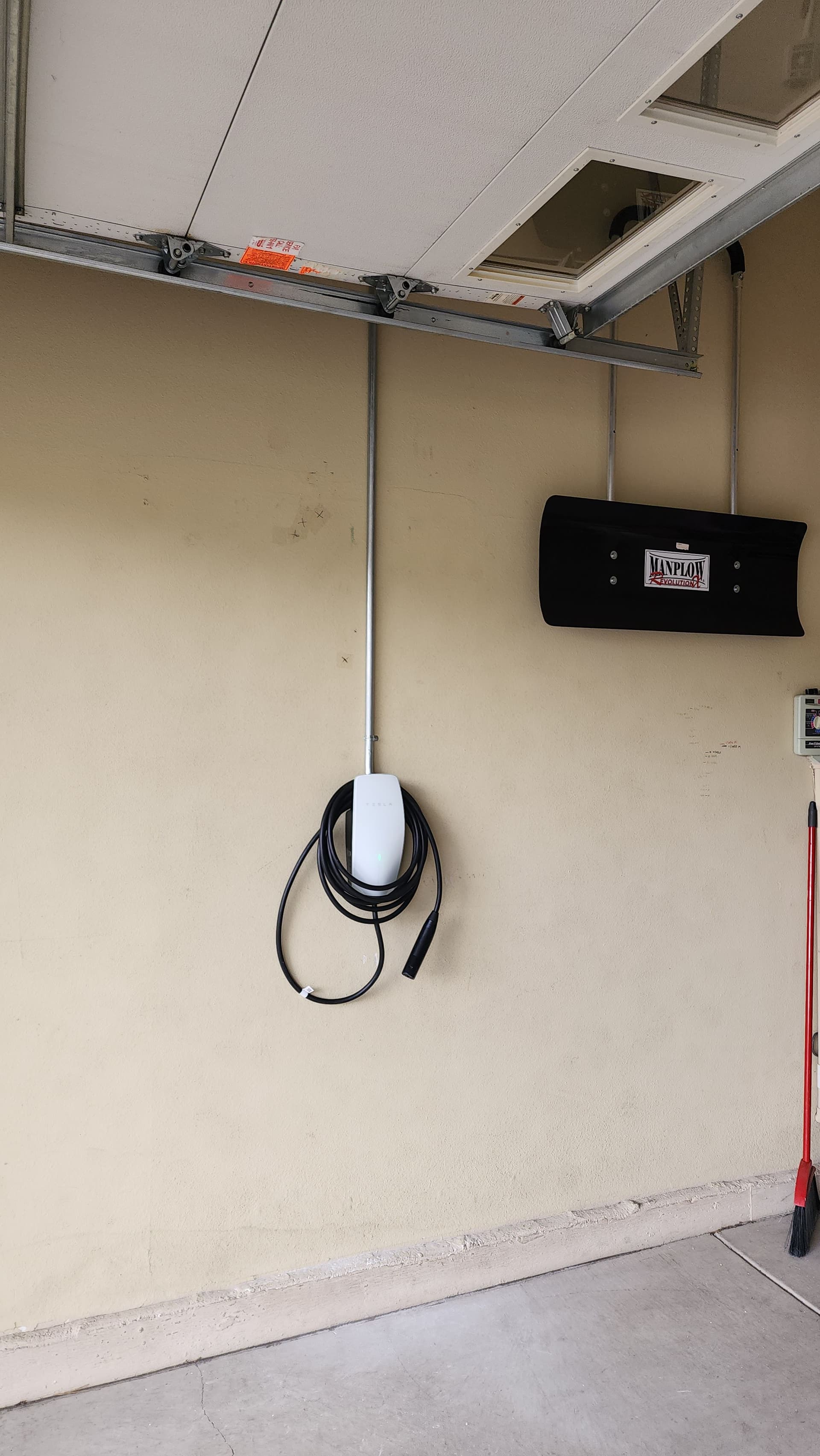 Tesla Wall Connector Installed Across Two Garages image
